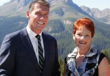One Nation Polls Past Coalition at 27-28% – Promises Mass Migration Caps, $90B Savings, Cheaper Power One Nation Two individuals in a mountainous landscape.