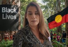 Parliament Shaken: Lidia Thorpe Slams Justice System After NT Police Escape Charges Senator Lidia Thorpe standing next to Aboriginal Flag and Blackside matters Photo created by Sammi